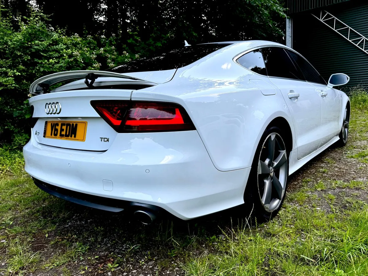 Rear three-quarter view of a freshly detailed white Audi A7
